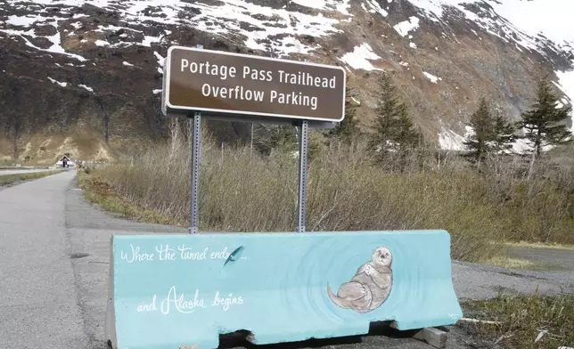 A sign is displayed along the road in Whittier, Alaska, on May 13, 2025, that says "Where the tunnel ends and Alaska begins." (AP Photo/Mark Thiessen)