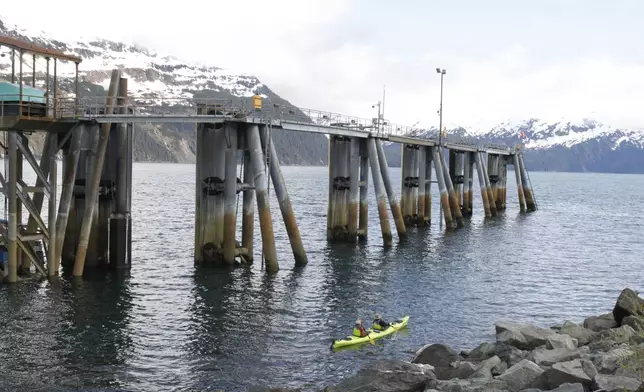 HOLD FOR STORY - Two people kayak around Blackstone Bay in Whittier, Alaska on May 13, 2025. (AP Photo/Mark Thiessen)