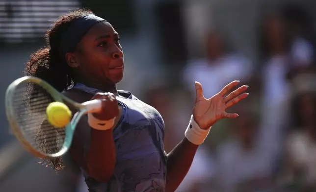 Coco Gauff of the U.S. returns the ball to Marie Bouzkova of the Czech Republic during their third round match of the French Tennis Open, at the Roland-Garros stadium, in Paris, Saturday, May 31, 2025. (AP Photo/Christophe Ena)