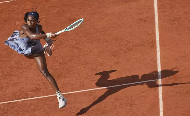 Coco Gauff of the U.S. returns the ball to Marie Bouzkova of the Czech Republic during their third round match of the French Tennis Open, at the Roland-Garros stadium, in Paris, Saturday, May 31, 2025. (AP Photo/Christophe Ena)