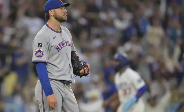 Los Angeles Dodgers' Max Muncy watches the flight of the ball on a two-run home run during the first inning of a baseball game against the New York Mets, Tuesday, June 3, 2025, in Los Angeles. (AP Photo/Jayne Kamin-Oncea)