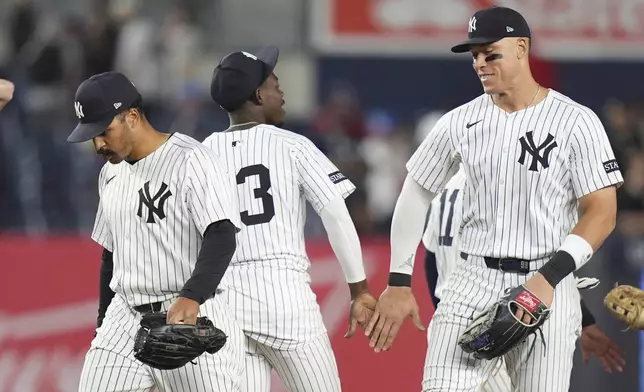 New York Yankees' Trent Grisham, left, celebrates with teammates New York Yankees' Jazz Chisholm Jr., center, and Aaron Judge after a baseball game against the Cleveland Guardians, Tuesday, June 3, 2025, in New York. (AP Photo/Frank Franklin II)
