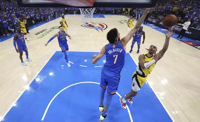 Indiana Pacers guard Andrew Nembhard (2) shoots against Oklahoma City Thunder forward Chet Holmgren (7) during the first half of Game 7 of the NBA Finals basketball series Sunday, June 22, 2025, in Oklahoma City. (Matthew Stockman/Pool Photo via AP)
