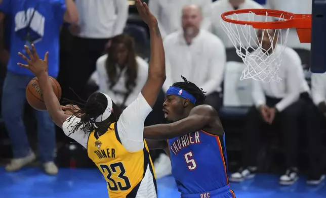 Oklahoma City Thunder guard Luguentz Dort (5) passes against Indiana Pacers center Myles Turner (33) during the second half of Game 7 of the NBA Finals basketball series Sunday, June 22, 2025, in Oklahoma City. (AP Photo/Nate Billings)