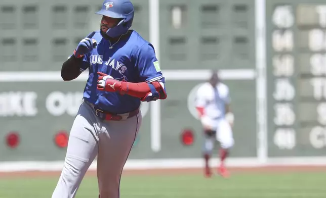 Toronto Blue Jays Vladimir Guerrero Jr. gestures after hitting a home run during the first inning of a baseball game against the Boston Red Sox, Sunday, June 29, 2025, in Boston. (AP Photo/Mark Stockwell)