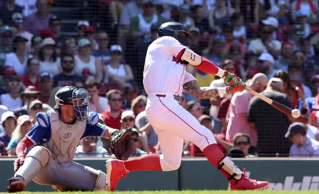 Boston Red Sox's Jarren Duran hits for a triple during the sixth inning of a baseball game against the Toronto Blue Jays, Sunday, June 29, 2025, in Boston. (AP Photo/Mark Stockwell)