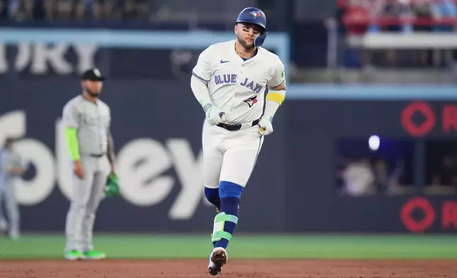 Toronto Blue Jays' Bo Bichette (11) rounds the bases after hitting a lead off home run off Chicago White Sox pitcher Aaron Civale in the first inning of a baseball game, Saturday June 21, 2025, in Toronto. (Chris Young/The Canadian Press via AP)