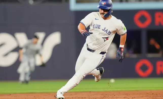 Toronto Blue Jays' Davis Schneider (36) rounds second base on a single from Myles Straw off Chicago White Sox pitcher Aaron Civale during the second inning of a baseball game in Toronto, Saturday June 21, 2025. (Chris Young/The Canadian Press via AP)