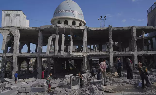 Palestinians inspect the rubble at the Al-Ansar Mosque following an Israeli strike in Deir al-Balah, Gaza Strip, Monday, June 2, 2025. (AP Photo/Abdel Kareem Hana)