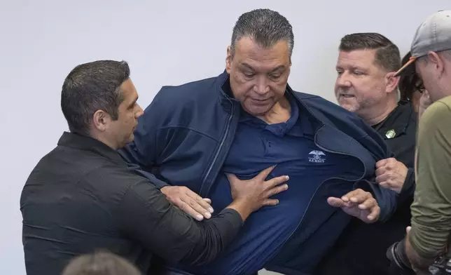 U.S. Sen. Alex Padilla, D-Calif., is pushed out of the room as Homeland Security Secretary Kristi Noem holds a news conference regarding the recent protests in Los Angeles, Thursday, June 12, 2025. (David Crane/The Orange County Register via AP)