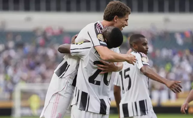 Juventus' Randal Kolo Muani lifts Kenan Yildiz after he scored second goal during the Club World Cup Group G soccer match between Juventus and Wydad AC in Philadelphia, Sunday, June 22, 2025. (AP Photo/Chris Szagola)