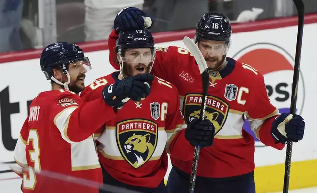 Florida Panthers' Matthew Tkachuk, center, celebrates after his goal against the Edmonton Oilers with Sam Reinhart, left, and Aleksander Barkov, right, during the first period in Game 4 of the NHL hockey Stanley Cup Final in Sunrise, Fla., Thursday, June 12, 2025. (Nathan Denette/The Canadian Press via AP)