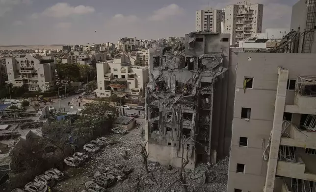 Israeli soldiers and rescue team work amid the rubble of residential buildings destroyed by an Iranian missile strike that killed several people, in Beersheba, Israel, on Tuesday, June 24, 2025. (AP Photo/Leo Correa)
