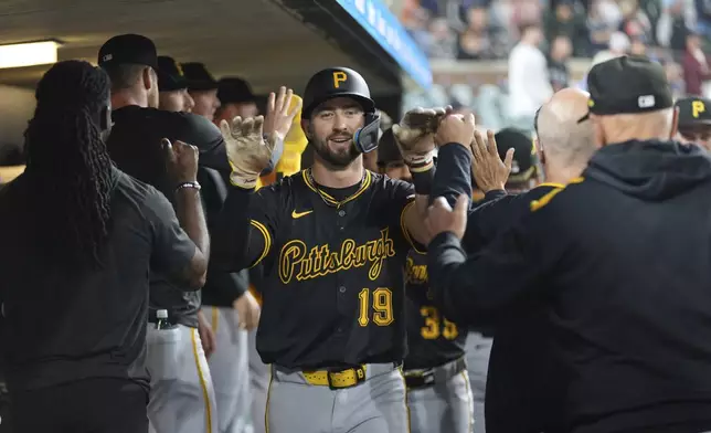 Pittsburgh Pirates' Jared Triolo (19) celebrates scoring against the Detroit Tigers in the 10th inning during the second baseball game of a doubleheader, Thursday, June 19, 2025, in Detroit. (AP Photo/Paul Sancya)