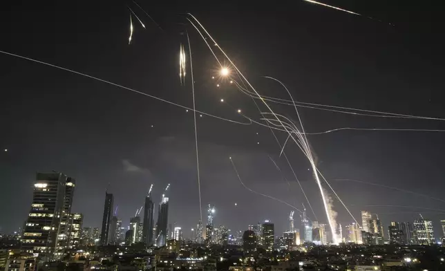 FILE - Israeli Iron Dome air defense system fires to intercept missiles over Tel Aviv, Israel, on June 13, 2025. (AP Photo/Leo Correa, File)