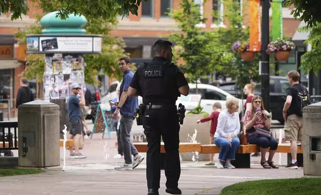 Boulder, Colo. Police Department officer patrols along the Pearl Street Mall outside of the Boulder County, Colo., courthouse, Monday, June 2, 2025, in Boulder, Colo. (AP Photo/David Zalubowski)