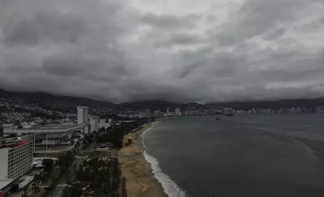 Acapulco Bay is void of boats while they are stored on shore as Hurricane Erick brings dark clouds, Thursday, June 19, 2025. (AP Photo/Fernando Llano)default