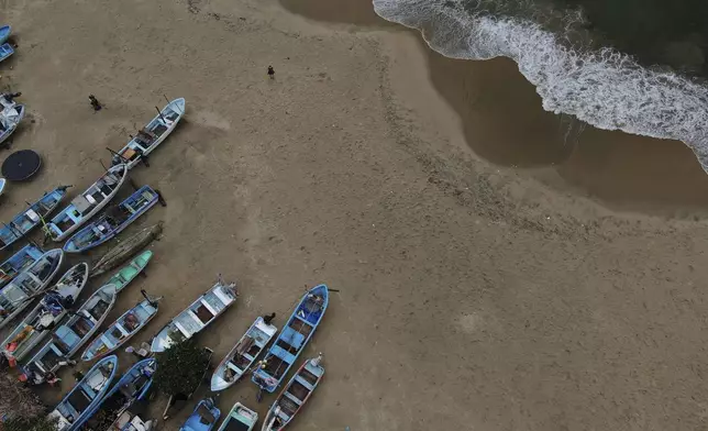 Fishing boats sit on Manzanillo beach for safe keeping after Hurricane Erick hit near Acapulco, Mexico, Thursday, June 19, 2025. (AP Photo/Fernando Llano)