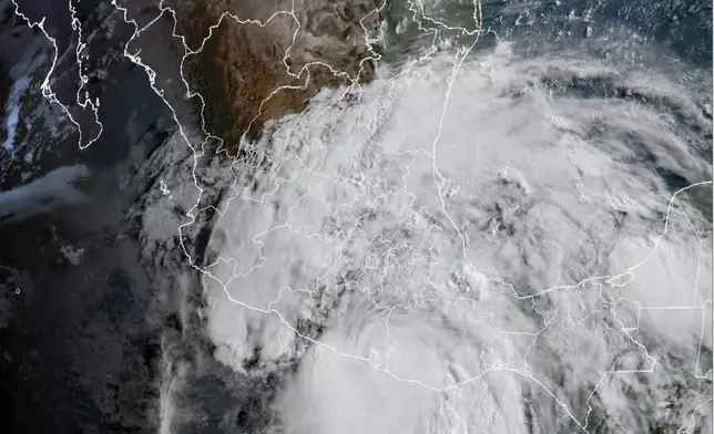 This satellite image provided by the National Oceanic and Atmospheric Administration (NOAA) shows Hurricane Erick making landfall in Mexico early Thursday, June 19, 2025. (NOAA via AP)