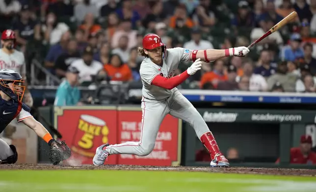 Philadelphia Phillies' Alec Bohm strikes out against Houston Astros relief pitcher Bryan Abreu during the ninth inning of a baseball game, Thursday, June 26, 2025, in Houston. (AP Photo/Karen Warren)