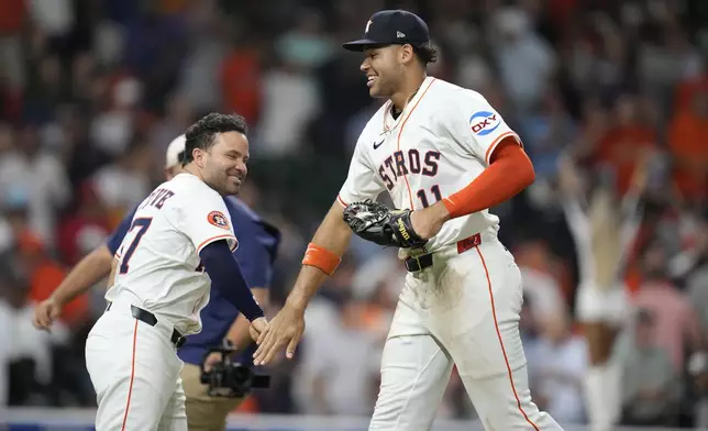 Houston Astros' Jose Altuve, right, and Cam Smith, left, celebrate after their win over the Philadelphia Phillies in a baseball game, Thursday, June 26, 2025, in Houston. (AP Photo/Karen Warren)