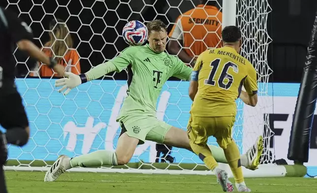 Boca Juniors' Miguel Merentiel (16) scores his side's first goal in front of Bayern Munich's Manuel Neuer during the Club World Cup Group C soccer match between Bayern Munich and Boca Juniors in Miami Gardens, Fla., Friday, June 20, 2025. (AP Photo/Rebecca Blackwell)