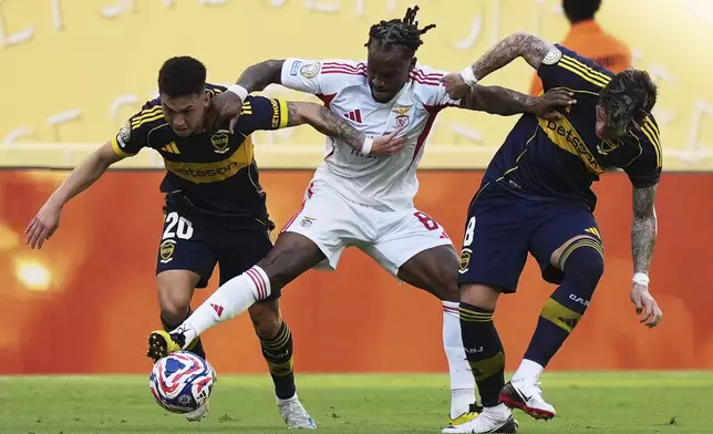 Benfica's Renato Sanches, center, fights for the ball with Boca Juniors' Carlos Palacios, right, and Alan Velasco (20) during the Club World Cup group C soccer match between Boca Juniors and Benfica in Miami Gardens, Fla., Monday, June 16, 2025. (AP Photo/Rebecca Blackwell)