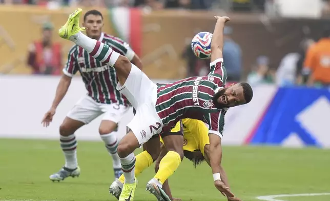 Fluminense's Samuel Xavier (2), and Borussia Dortmund's Karim Adeyemi collide as they battle for the ball during the Club World Cup group F soccer match between Fluminense and Borussia Dortmund in East Rutherford, N.J., Tuesday, June 17, 2025. (AP Photo/Frank Franklin II)