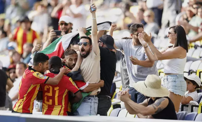 Esperance de Tunis' Youcef Belaïli celebrates after scoring with fans, Mohamed Ben Ali and Abdramane Konate during the Club World Cup Group D soccer match between Los Angeles FC and ES Tunisie in Nashville, Tenn., Friday, June 20, 2025. (AP Photo/Johnnie Izquierdo)