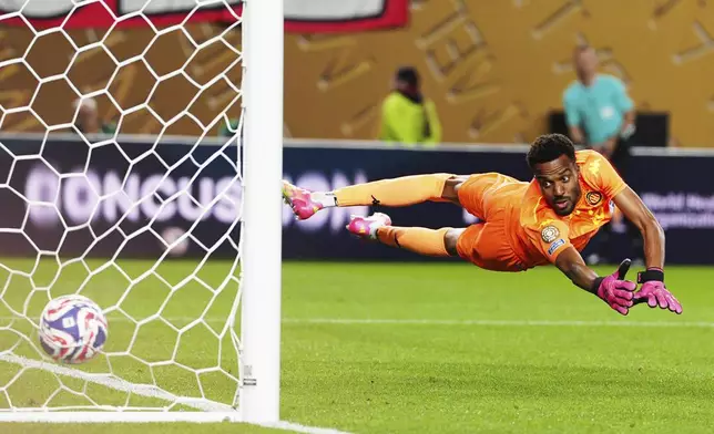 Esperance de Tunis' goalkeeper Bechir Ben Said is airborne as he fails to stop a goal from Flamengo's Luiz Arajo during the Club World Cup group D soccer match between Flamengo and ES Tunisie, in Philadelphia, Monday, June 16, 2025. (AP Photo/Derik Hamilton)