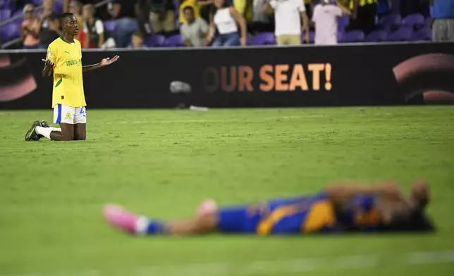 Mamelodi Sundowns' Divine Lunga reacts as Ulsan HD's Ko Seung-beom lays on the pitch after the Club World Cup group F soccer match between Ulsan HD and Mamelodi Sundowns in Orlando, Tuesday, June 17, 2025. (AP Photo/Phelan M. Ebenhack)
