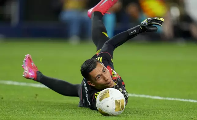 Mexico goalkeeper Ángel Malagón makes a save on a shot by Suriname midfielder Denzel Jubitana during a CONCACAF Gold Cup soccer match Wednesday, June 18, 2025, in Arlington, Texas. (AP Photo/Julio Cortez)