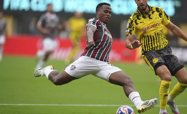 Fluminense's Jhon Arias takes a shot challenged by Borussia Dortmund's Ramy Bensebaini during the Club World Cup group F soccer match between Fluminense and Borussia Dortmund in East Rutherford, N.J., Tuesday, June 17, 2025. (AP Photo/Frank Franklin II)