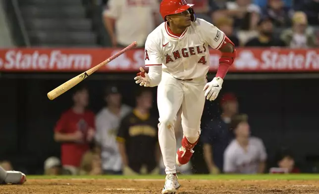 Los Angeles Angels second baseman Christian Moore flips his bat after hitting a walk-off two-run home run in the 10th inning of a baseball game against the Boston Red Sox, Tuesday, June 24, 2025, in Anaheim, Calif. (AP Photo/Jayne Kamin-Oncea)