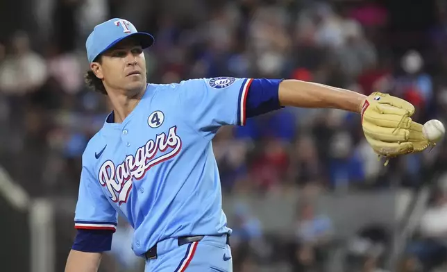 Texas Rangers starting pitcher Jacob deGrom reaches for the throw back to the mound during the fourth inning of a baseball game against the St. Louis Cardinals, Sunday, June 1, 2025, in Arlington, Texas. (AP Photo/LM Otero)