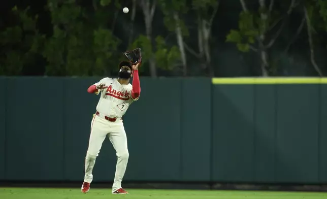 Los Angeles Angels center fielder Jo Adell makes a catch during the 10th inning of a baseball game against the Houston Astros, Friday, June 20, 2025, in Anaheim, Calif. (AP Photo/William Liang)