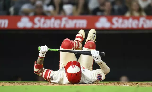 Los Angeles Angels' Zach Neto falls to the floor after striking out during the seventh inning of a baseball game against the Houston Astros, Friday, June 20, 2025, in Anaheim, Calif. (AP Photo/William Liang)