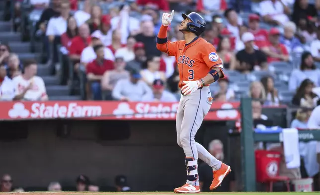 Houston Astros Jeremy Peña gestures after hitting a home run during the first inning of a baseball game against the Los Angeles Angels, Friday, June 20, 2025, in Anaheim, Calif. (AP Photo/William Liang)