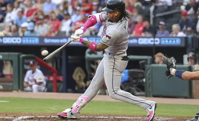 Arizona Diamondbacks' Ketel Marte hits a two-run home run in the third inning of a baseball game against the Atlanta Braves, Tuesday, June 3, 2025, in Atlanta. (AP Photo/Colin Hubbard)