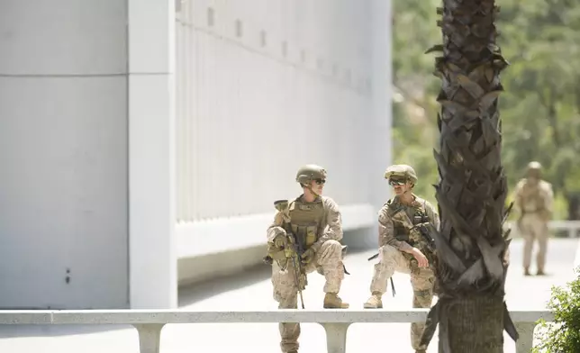 U.S Marines guard a federal building, Friday, June 13, 2025, in Los Angeles (AP Photo/Noah Berger)