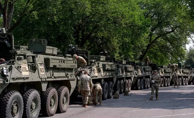 U.S. Army soldiers work on Stryker combat vehicles staged in West Potomac Park ahead of an upcoming military parade commemorating the Army's 250th anniversary and coinciding with Donald Trump's 79th birthday, Wednesday, June 11, 2025, in Washington (AP Photo/Julia Demaree Nikhinson)