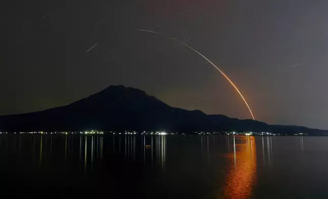 In this long exposure photo, an H-2A rocket carrying Global Observing SATellite for Greenhouse gases and Water cycle, or GOSAT-GW satellite, lifts off from Tanegashima Space Center, seen in Kagoshima, southern Japan, early Sunday, June 29, 2025. (Kotaro Ueda/Kyodo News via AP)