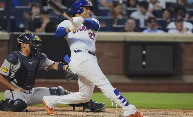 New York Mets' Juan Soto follows through on a home run during the fourth inning of a baseball game against the Atlanta Braves Wednesday, June 25, 2025, in New York. (AP Photo/Frank Franklin II)