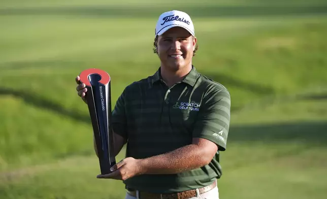 Aldrich Potgieter, of South Africa poses with the trophy after winning a playoff during the final round of the Rocket Classic golf tournament at the Detroit Golf Club, Sunday, June 29, 2025, in Detroit. (AP Photo/Paul Sancya)