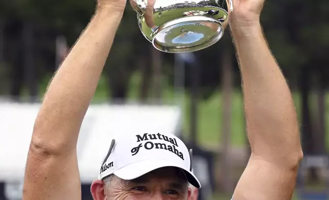 Padragh Harrington holds up the trophy after winning the U.S. Senior Open Championship golf tournament at the Broadmoor, Sunday, June 29, 2025, in Colorado Springs, Colo. (Jerilee Bennett/The Gazette via AP)