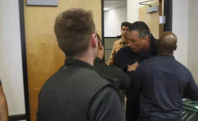 U.S. Sen. Alex Padilla, D-Calif., is pushed out of the room as Homeland Security Secretary Kristi Noem holds a news conference regarding the recent protests in Los Angeles on Thursday, June 12, 2025. (AP Photo/Etienne Laurent)