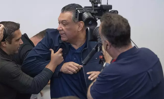 U.S. Sen. Alex Padilla, D-Calif., is pushed out of the room as Homeland Security Secretary Kristi Noem holds a news conference regarding the recent protests in Los Angeles, Thursday, June 12, 2025. (David Crane/The Orange County Register via AP)