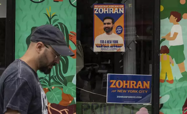 A campaign poster for Democratic mayoral candidate Zohran Mamdani is seen outside a store, Thursday, June. 26, 2025, in New York. (AP Photo/Yuki Iwamura)