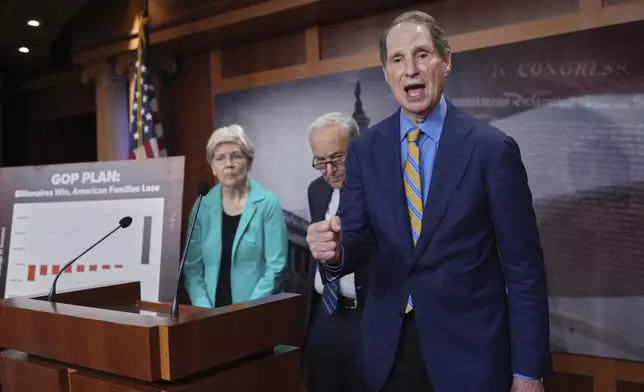 Sen. Ron Wyden, D-Ore., the ranking member of the Senate Finance Committee, is joined at left by Sen. Elizabeth Warren, D-Mass., ranking member of the Senate Banking, Housing, and Urban Affairs Committee, and Senate Minority Leader Chuck Schumer, D-N.Y., as they talk to reporters about Senate Republicans' efforts to pass President Donald Trump's tax cut and spending agenda with deeper Medicaid cuts, at the Capitol in Washington, Wednesday, June 18, 2025. (AP Photo/J. Scott Applewhite)