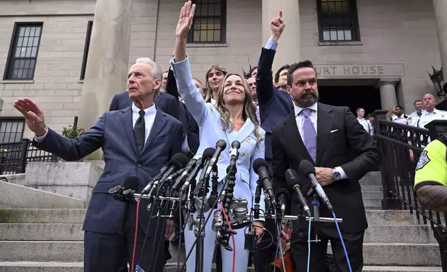 Karen Read, center, waves to supporters after she was found not guilty of second-degree murder on Wednesday, June 18, 2025, in Dedham, Mass. (AP Photo/Josh Reynolds)